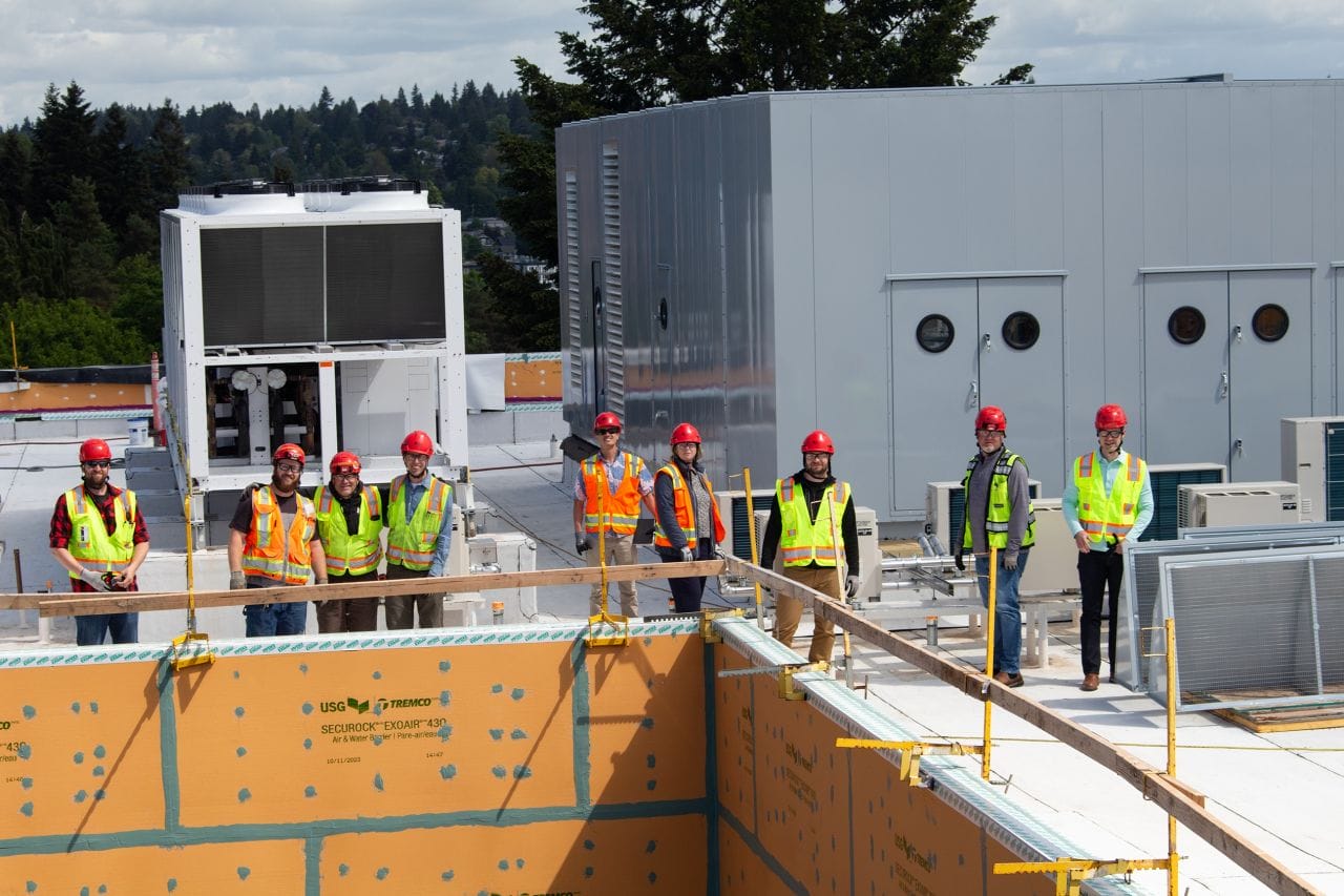 Group of Auburn Mechanical employees on rooftop of jobsite
