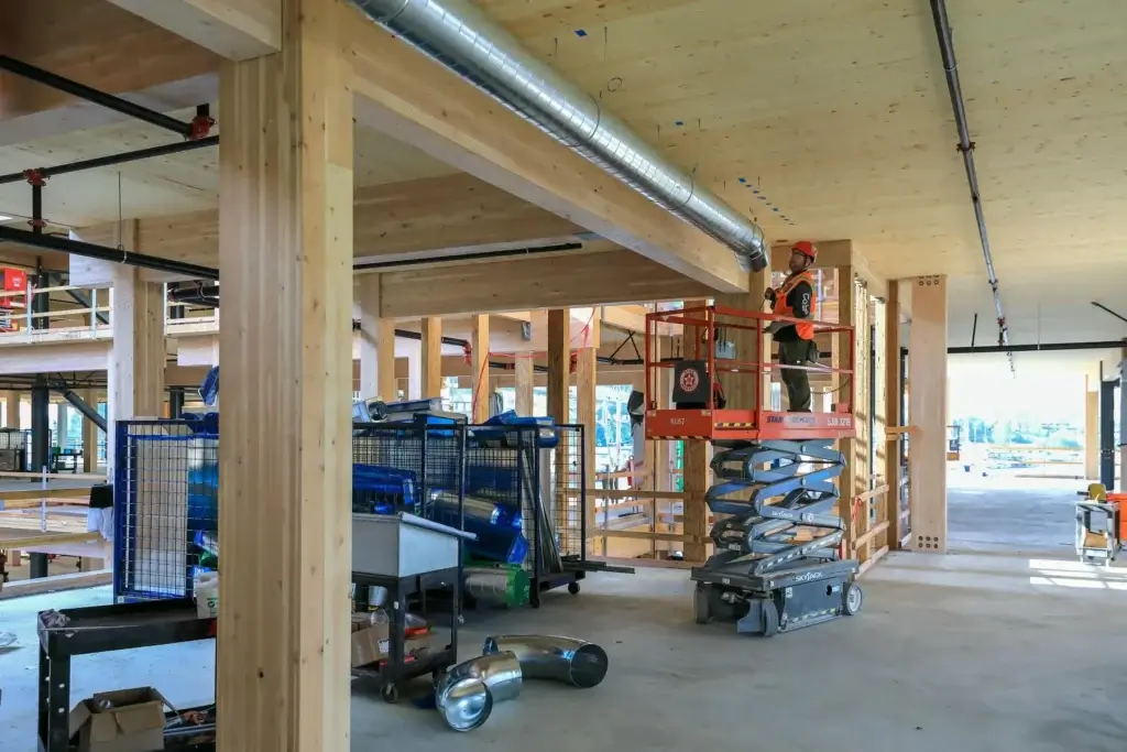 Auburn Mechanical employee on scissor lift inside jobsite