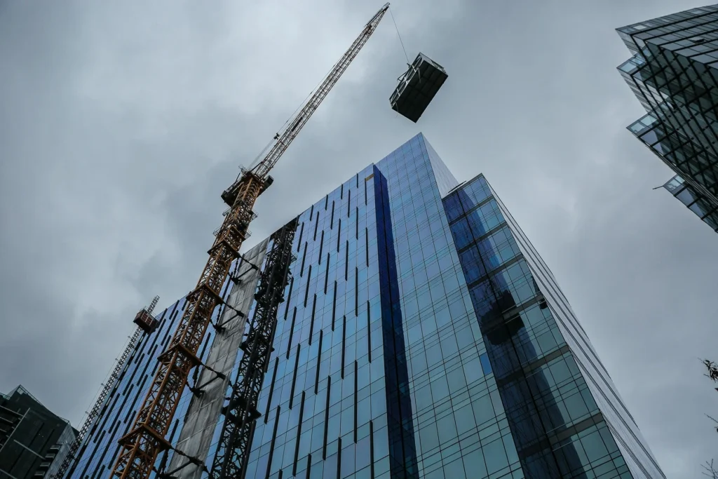 Building exterior with HVAC system on crane