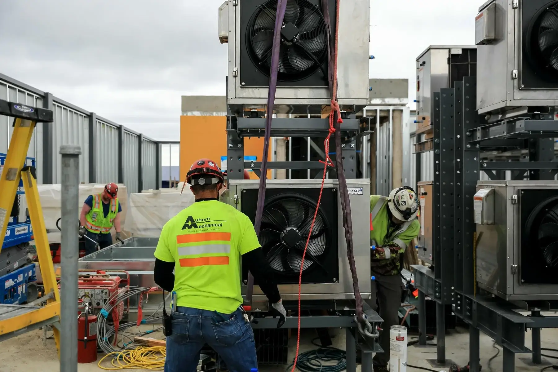 Auburn Mechanical employees installing HVAC system on rooftop