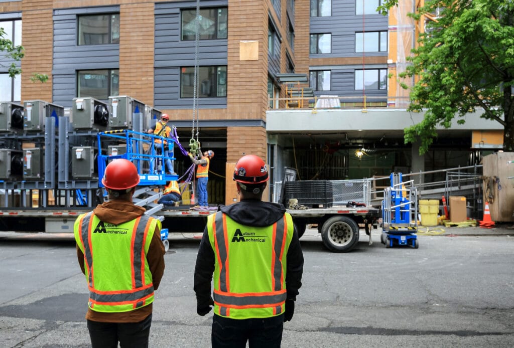 Auburn Mechanical employees on jobsite with hardhats