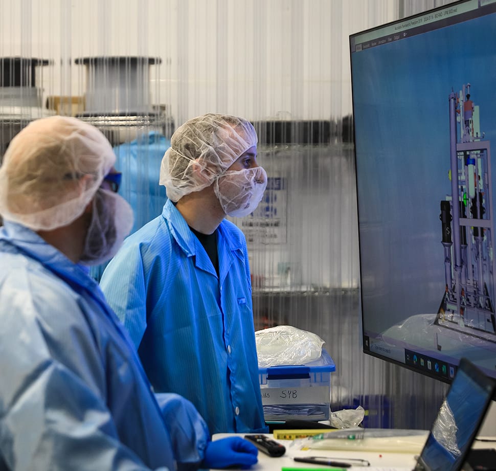 Pure Water employees reviewing drawings on screen