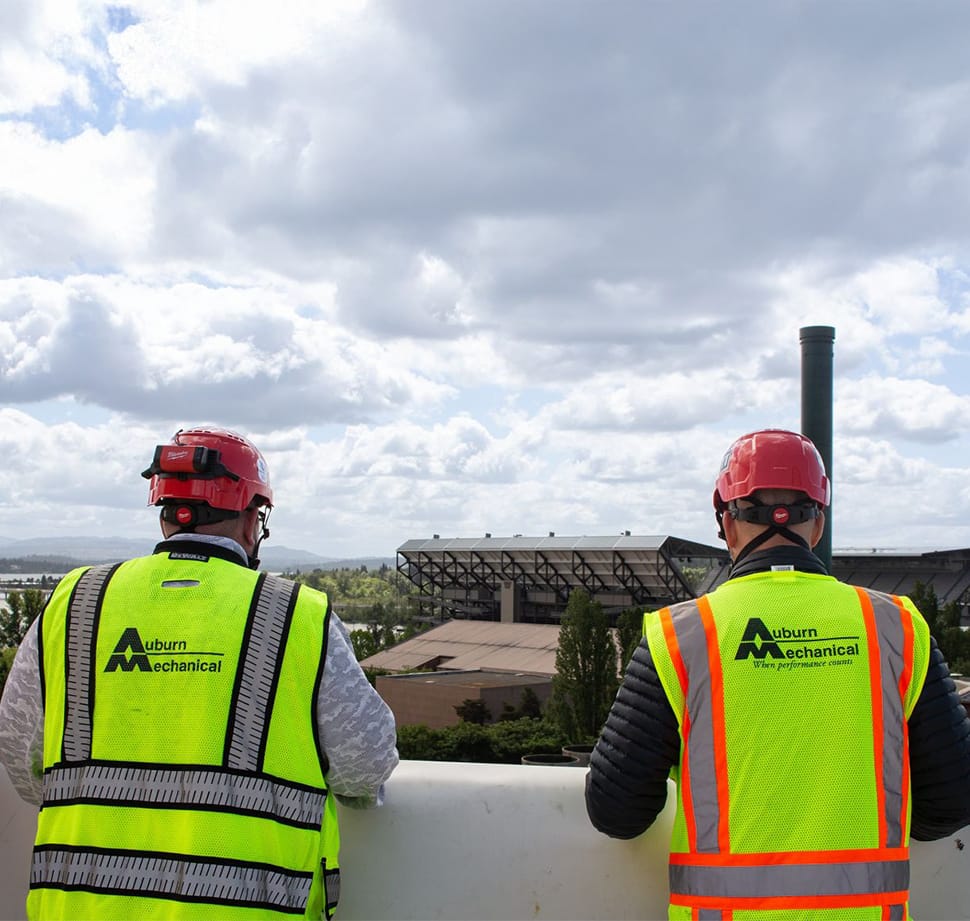 Auburn Mechanical employees on rooftop overlooking stadium