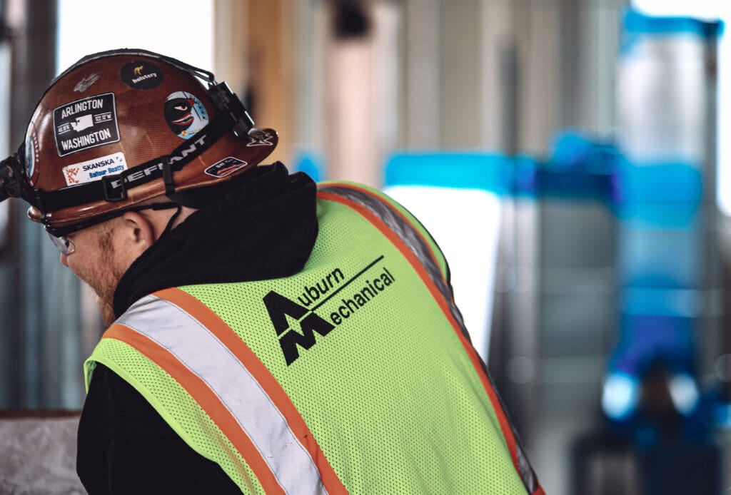 Auburn Mechanical employee on jobsite with hardhat